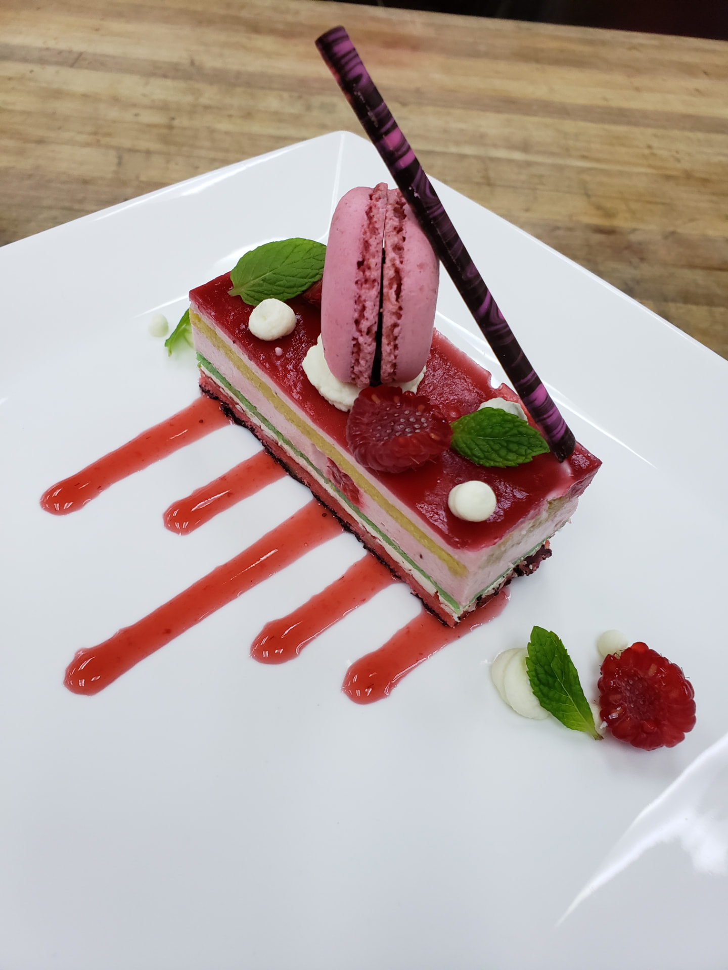 Haupia panna cotta with lilikoi coulis plated by Chef Dayne