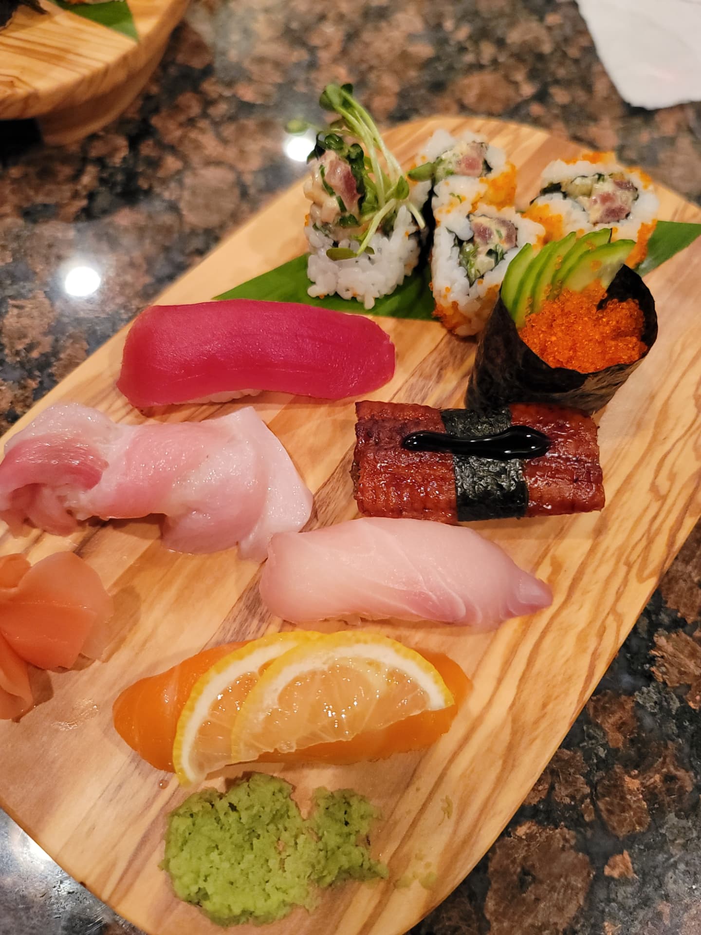 Assortment of nigiri, rolls and gunkan sushi on a wooden board