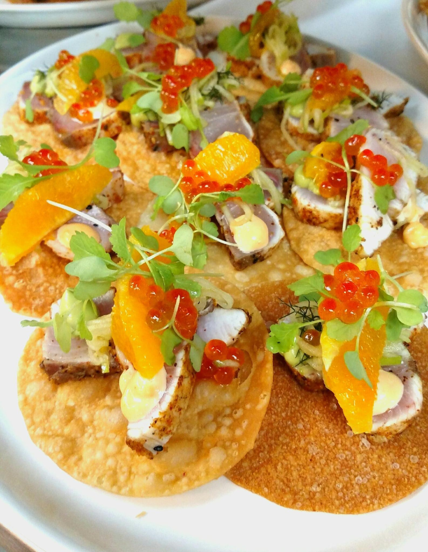 Seafood tostadas with citrus, roe and microgreens