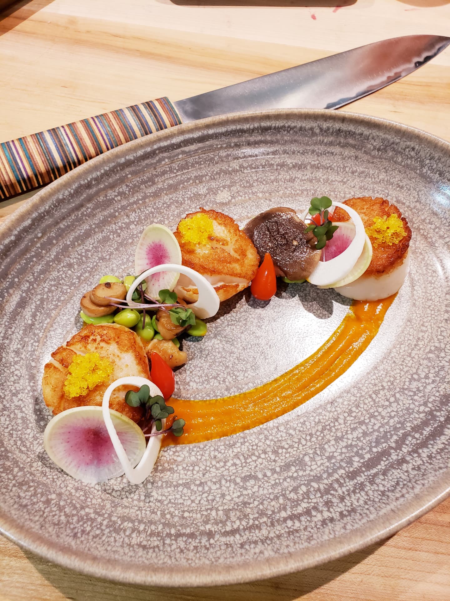 Seared scallops with mushrooms, radish and orange sauce